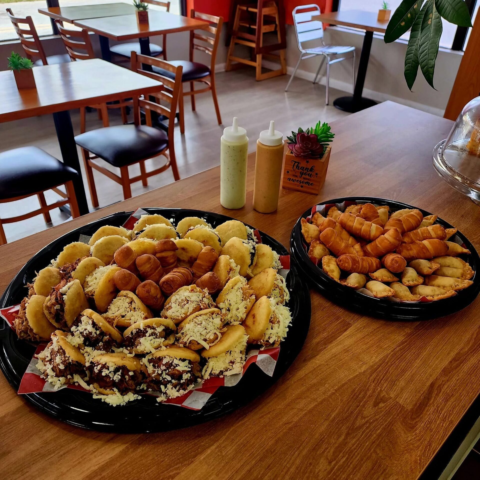 Two 1Chick 1Bro party platters on the table in the orange dining room