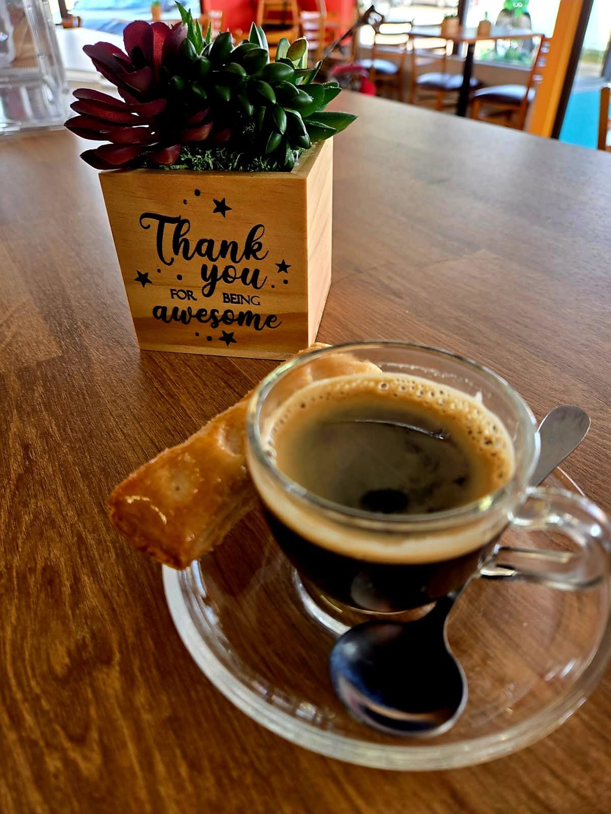 Espresso in a glass cup beside the 'Thank you for being awesome' card on a 1Chick 1Bro table